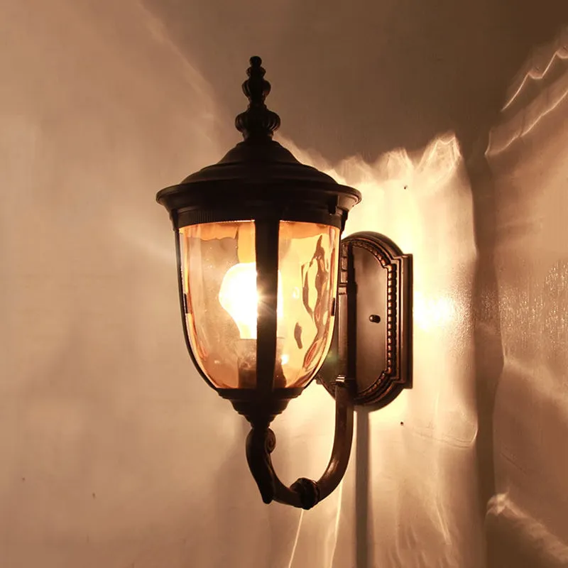 Traditional Wall Sconce: 1-Light Black Lamp with Amber Water Glass Urn Shade